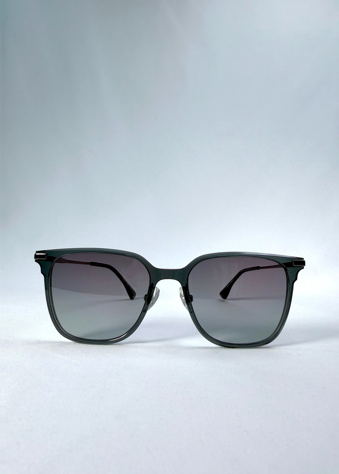 Front view of Eon Drift sunglasses in Onyx Fade, featuring a dark onyx frame and gray gradient lenses, showing the full front silhouette.