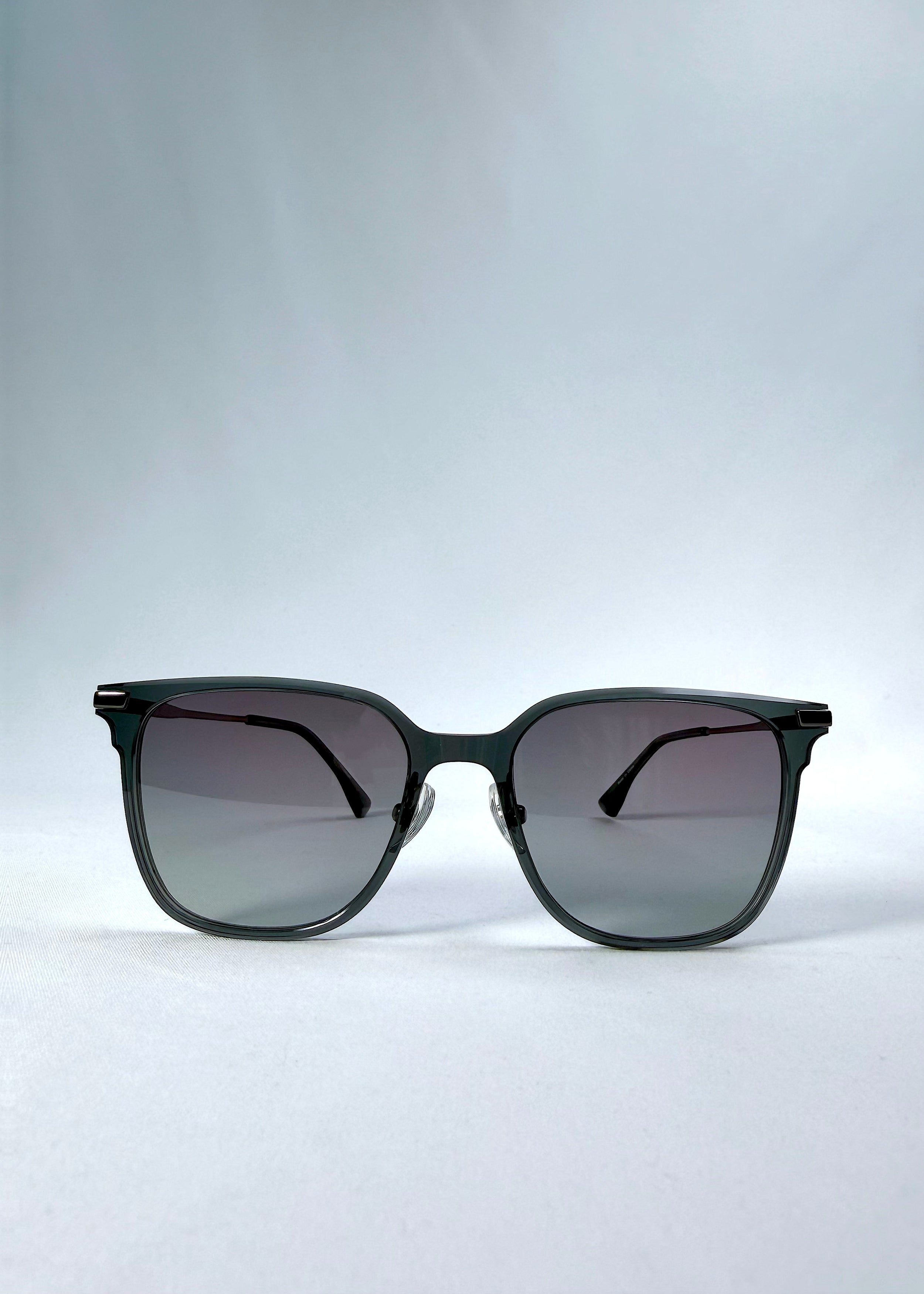 Front view of Eon Drift sunglasses in Onyx Fade, featuring a dark onyx frame and gray gradient lenses, showing the full front silhouette.