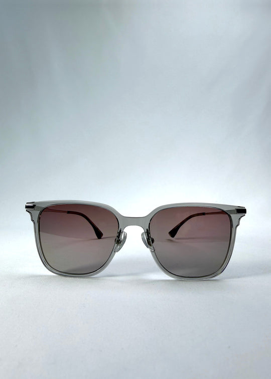 Front view of Eon Drift sunglasses in Rose Graphite, featuring a rose-gray frame and smoky gradient lenses, showing the full front silhouette.