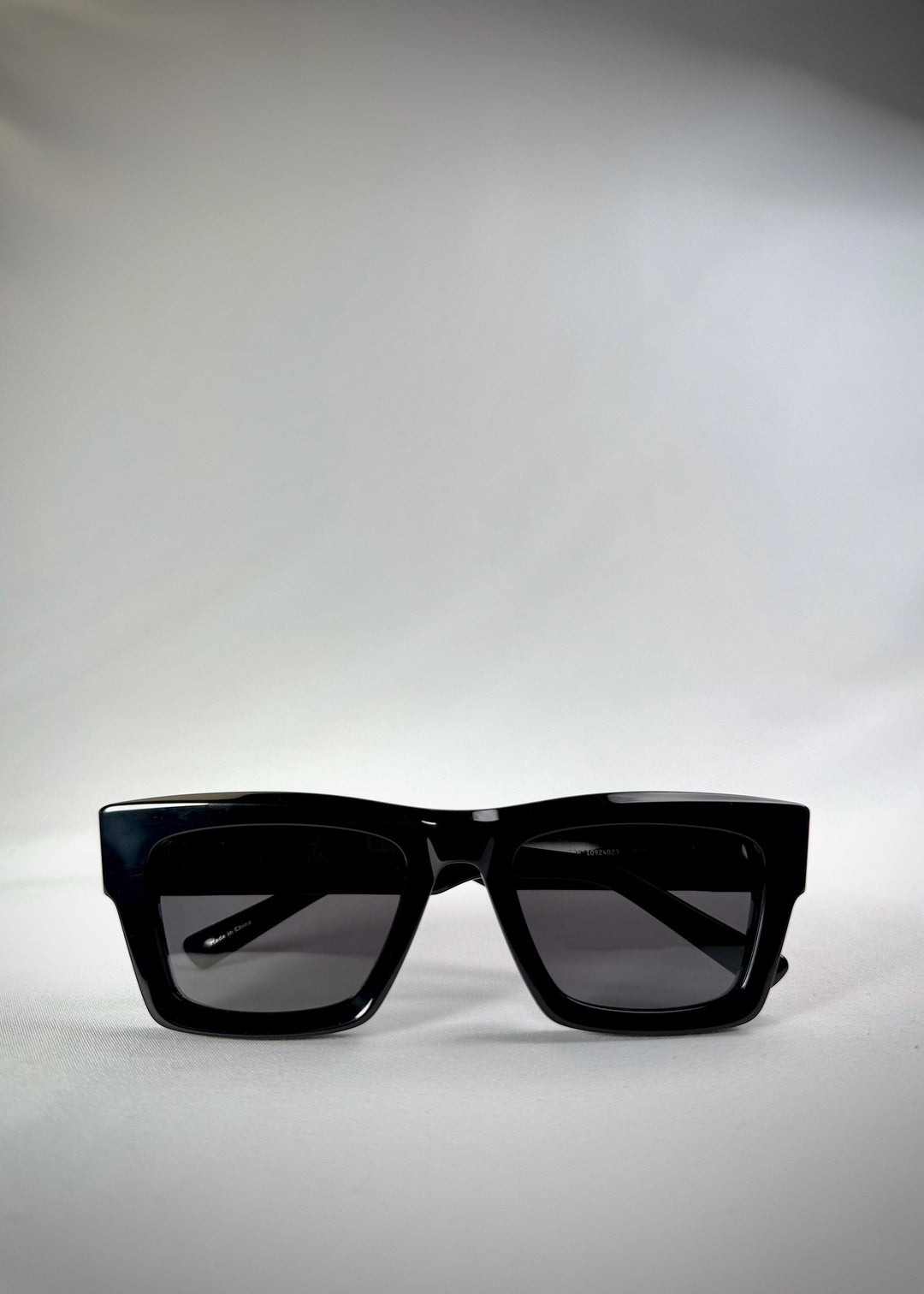 Folded view of Fomalhaut black acetate prescription sunglasses, showing the folded temples and frame profile. 