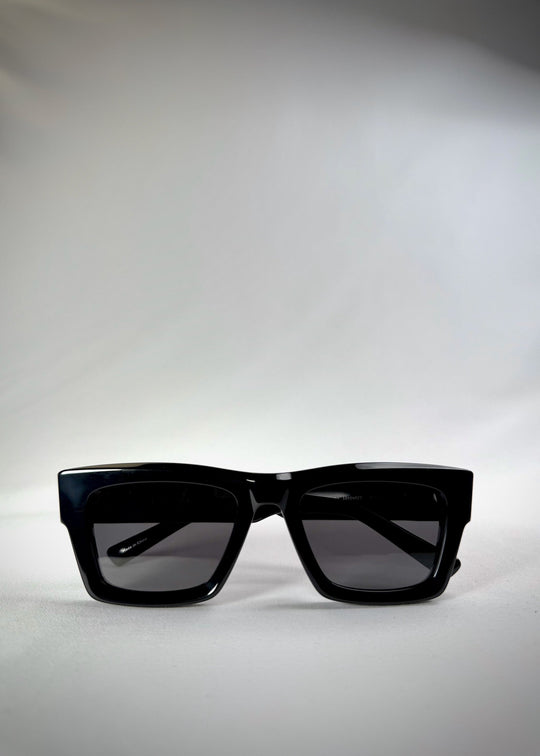 Folded view of Fomalhaut black acetate prescription sunglasses, showing the folded temples and frame profile. 
