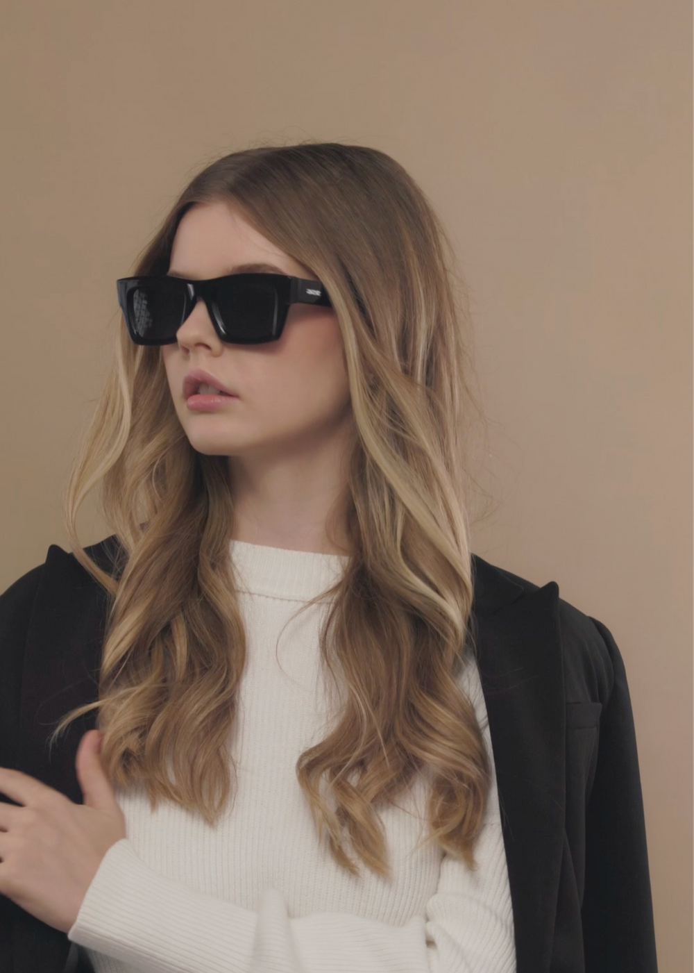 Female model styling Fomalhaut black acetate prescription sunglasses for a modern look.

