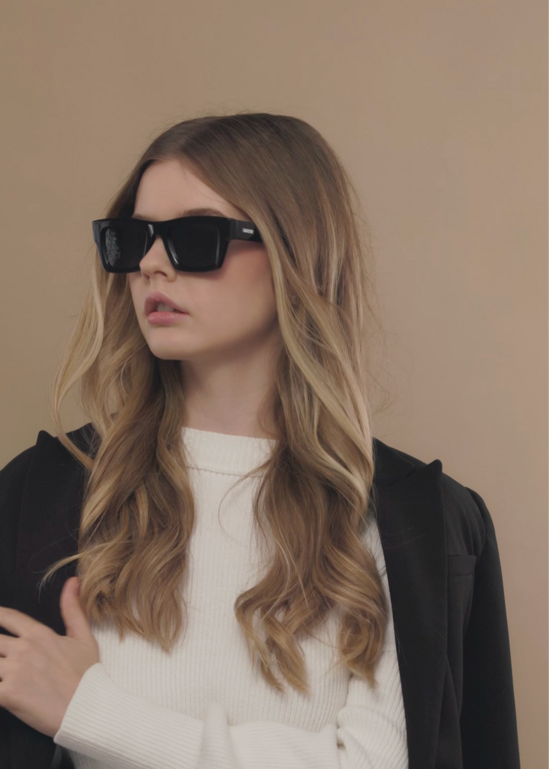Female model wearing Fomalhaut black acetate prescription sunglasses, styled for a modern everyday look. 