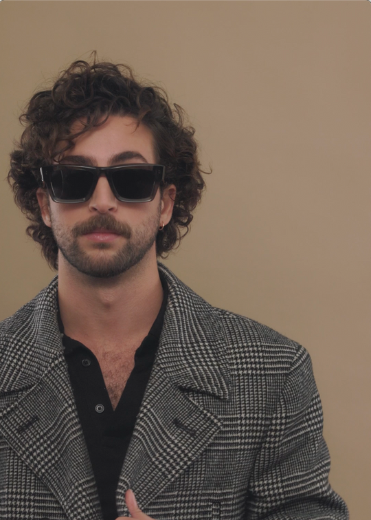 Male model wearing Fomalhaut gray-green acetate prescription sunglasses, styled for a modern look. 
