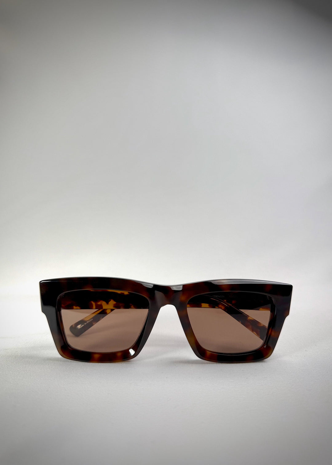 Folded view of Fomalhaut tortoiseshell acetate sunglasses, showing the folded temples and frame profile. 