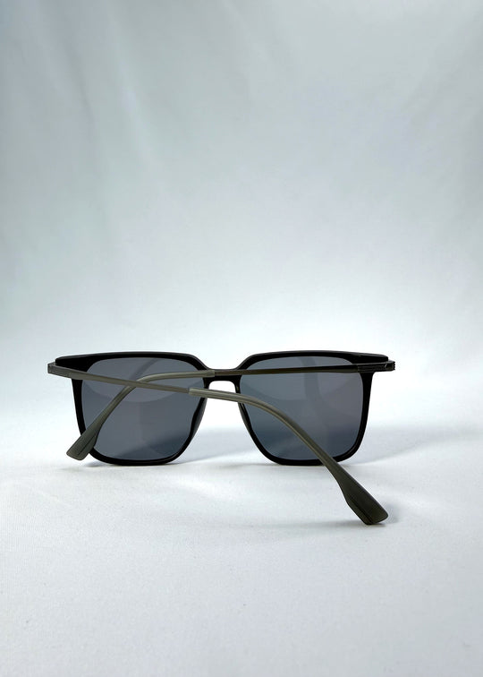 Folded view of Gemini sunglasses in Matte Black, featuring light titanium frame, squared lens shape, and polarized lenses, showing the folded temples and frame profile.