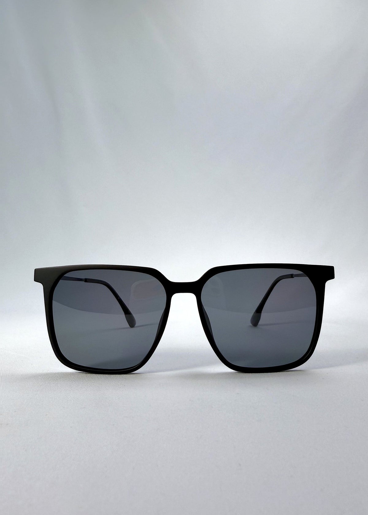 Front view of Gemini sunglasses in Matte Black, showing the full squared frame and polarized lenses.