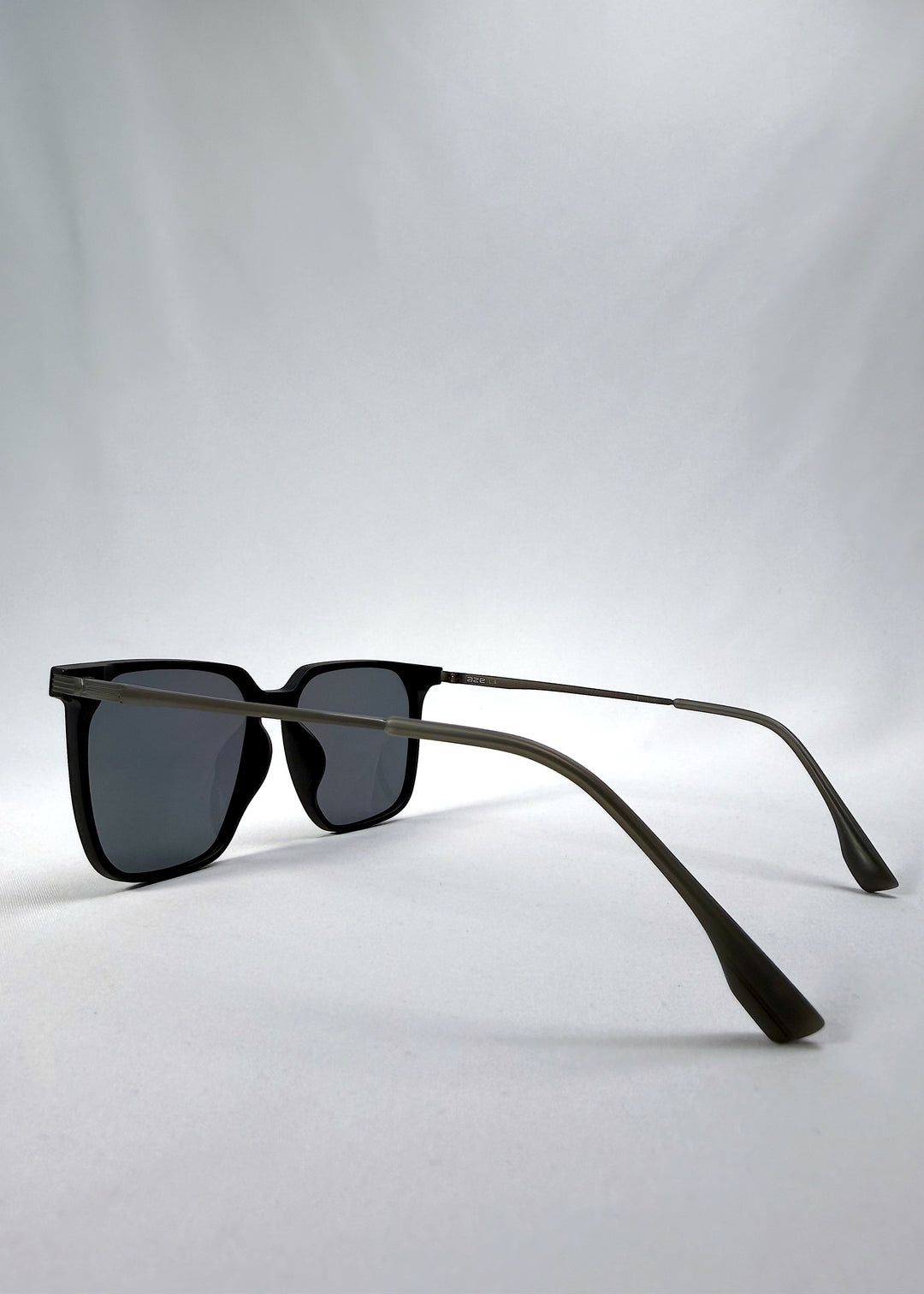 Side-angle view of Gemini sunglasses in Matte Black, featuring light titanium frame, squared lens shape, and polarized lenses, showing the lens shape and temple profile.