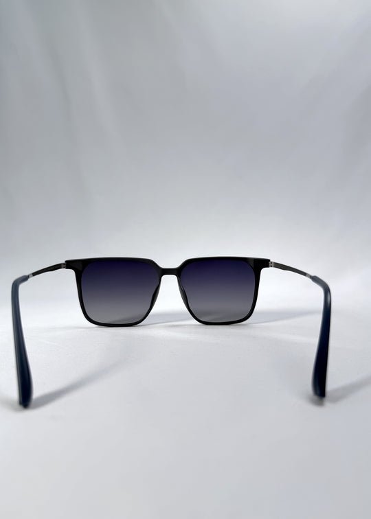 Back view of Gemini sunglasses in Matte Blue, featuring light titanium frame, squared lens shape, and polarized lenses, showing the inside frame and open temples.