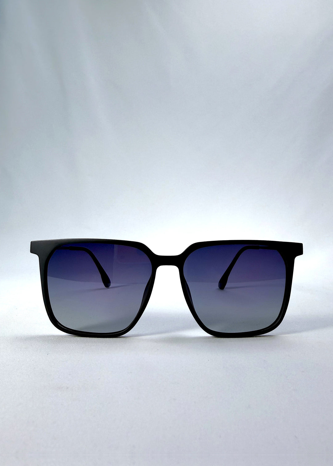 Front view of Gemini sunglasses in Matte Blue, featuring light titanium frame, squared lens shape, and polarized lenses, showing the full front silhouette.