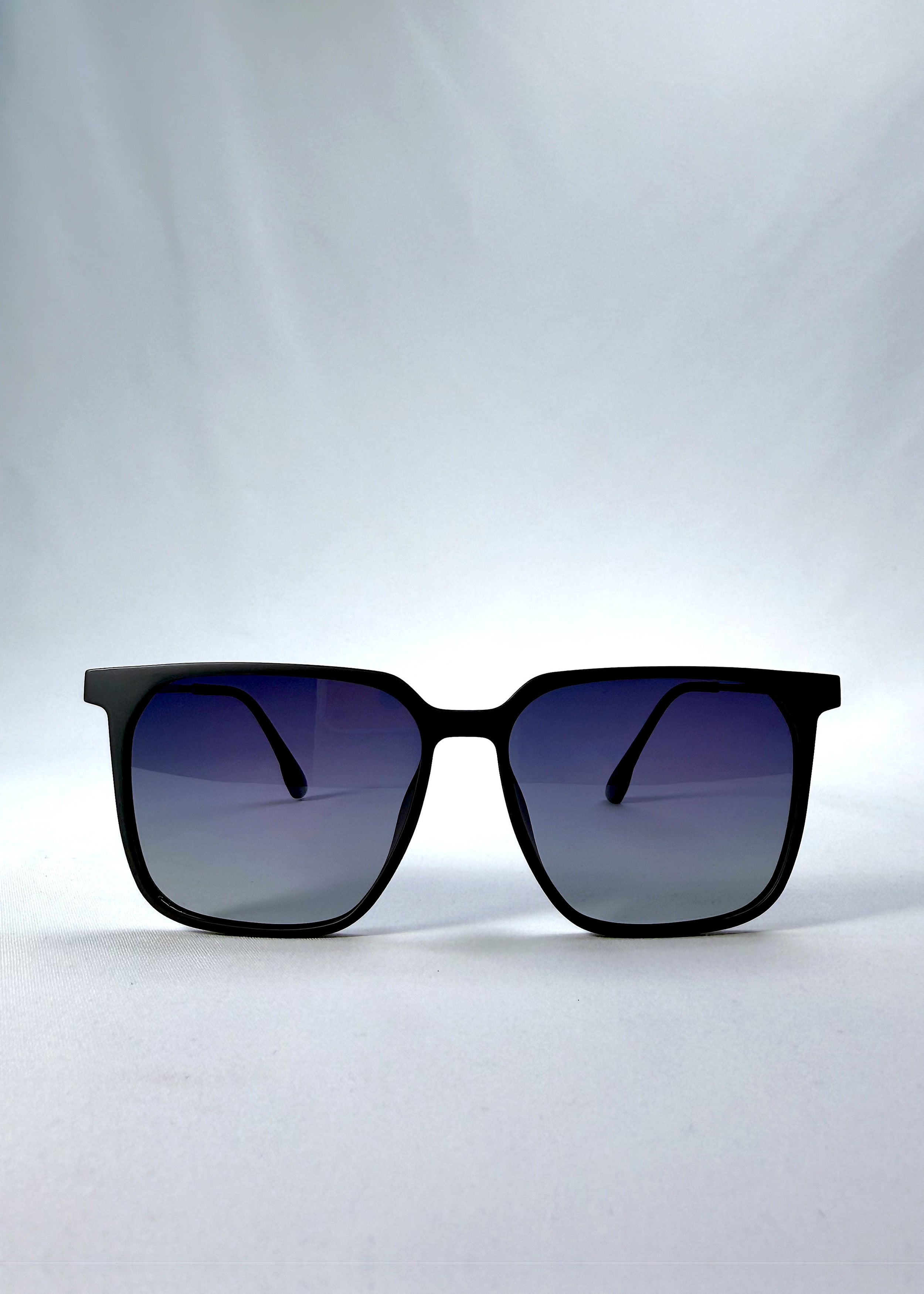 Front view of Gemini sunglasses in Matte Blue, featuring light titanium frame, squared lens shape, and polarized lenses, showing the full front silhouette.