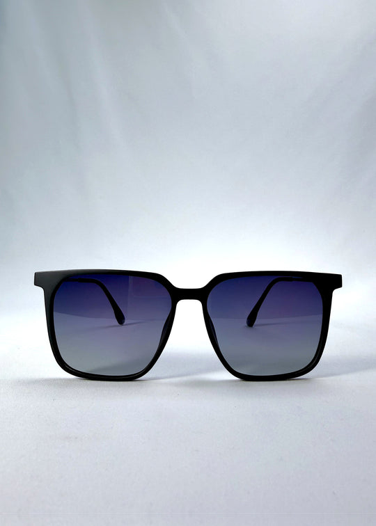 Front view of Gemini sunglasses in Matte Blue, featuring light titanium frame, squared lens shape, and polarized lenses, showing the full front silhouette.