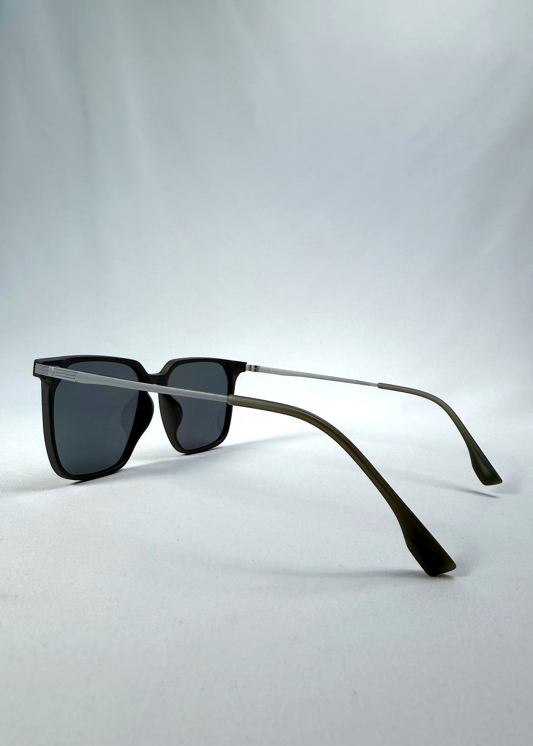 Side-angle view of Gemini sunglasses in Matte Gray, featuring light titanium frame, squared lens shape, and polarized lenses, showing the lens shape and temple profile.