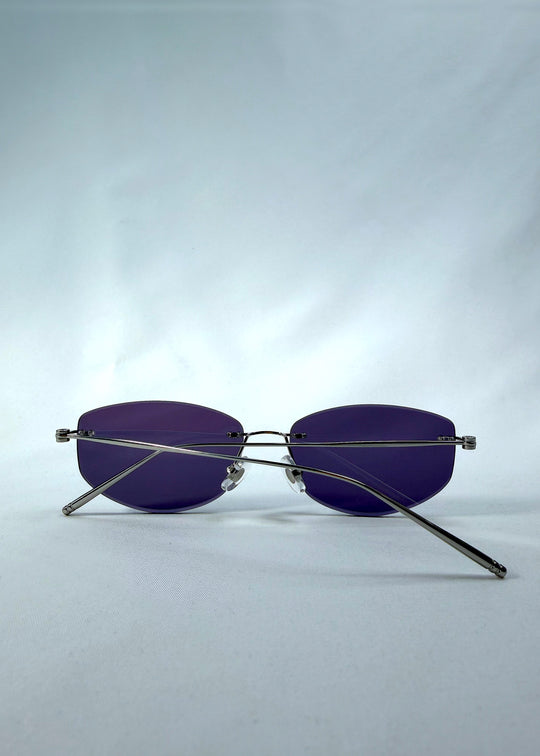Folded back view of Halo Trace sunglasses in Glacial Blue, featuring blue-grey nylon lenses and a lightweight titanium frame, showing the folded temples and back structure.