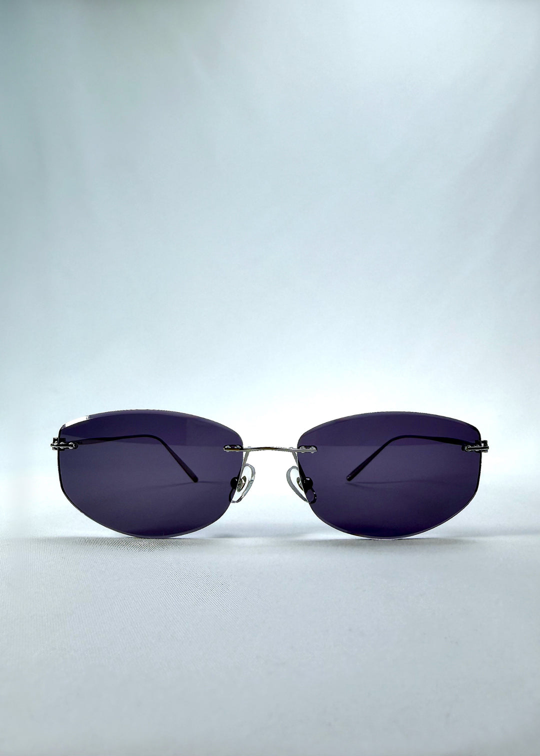 Front view of Halo Trace sunglasses in Glacial Blue, featuring blue-grey nylon lenses and a lightweight titanium frame, showing the full front silhouette.