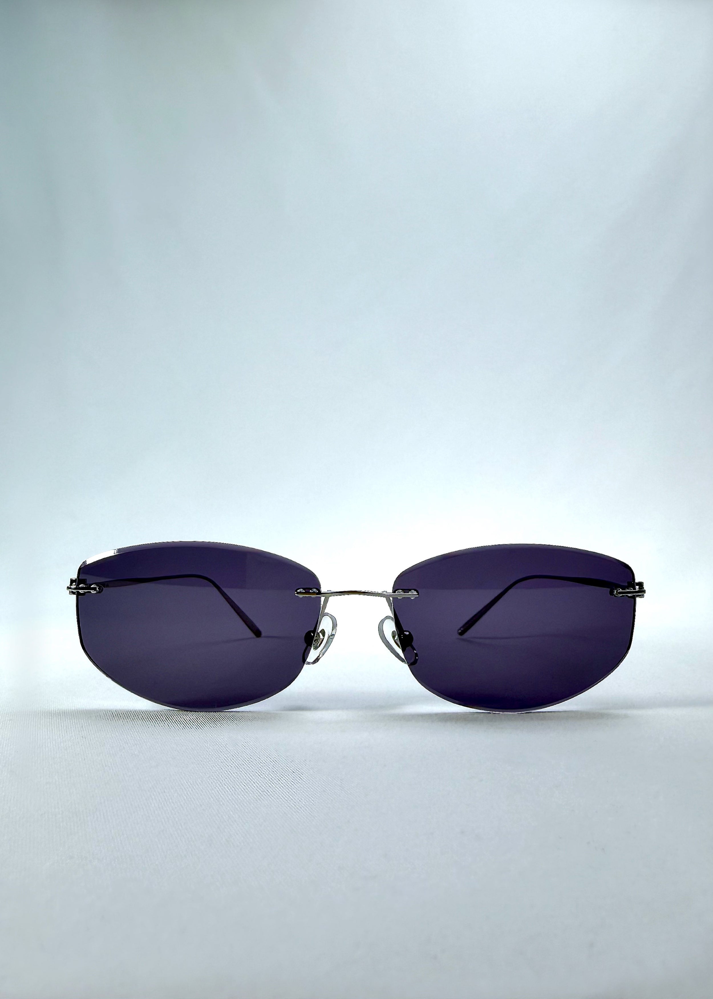Front view of Halo Trace sunglasses in Glacial Blue, featuring blue-grey nylon lenses and a lightweight titanium frame, showing the full front silhouette.