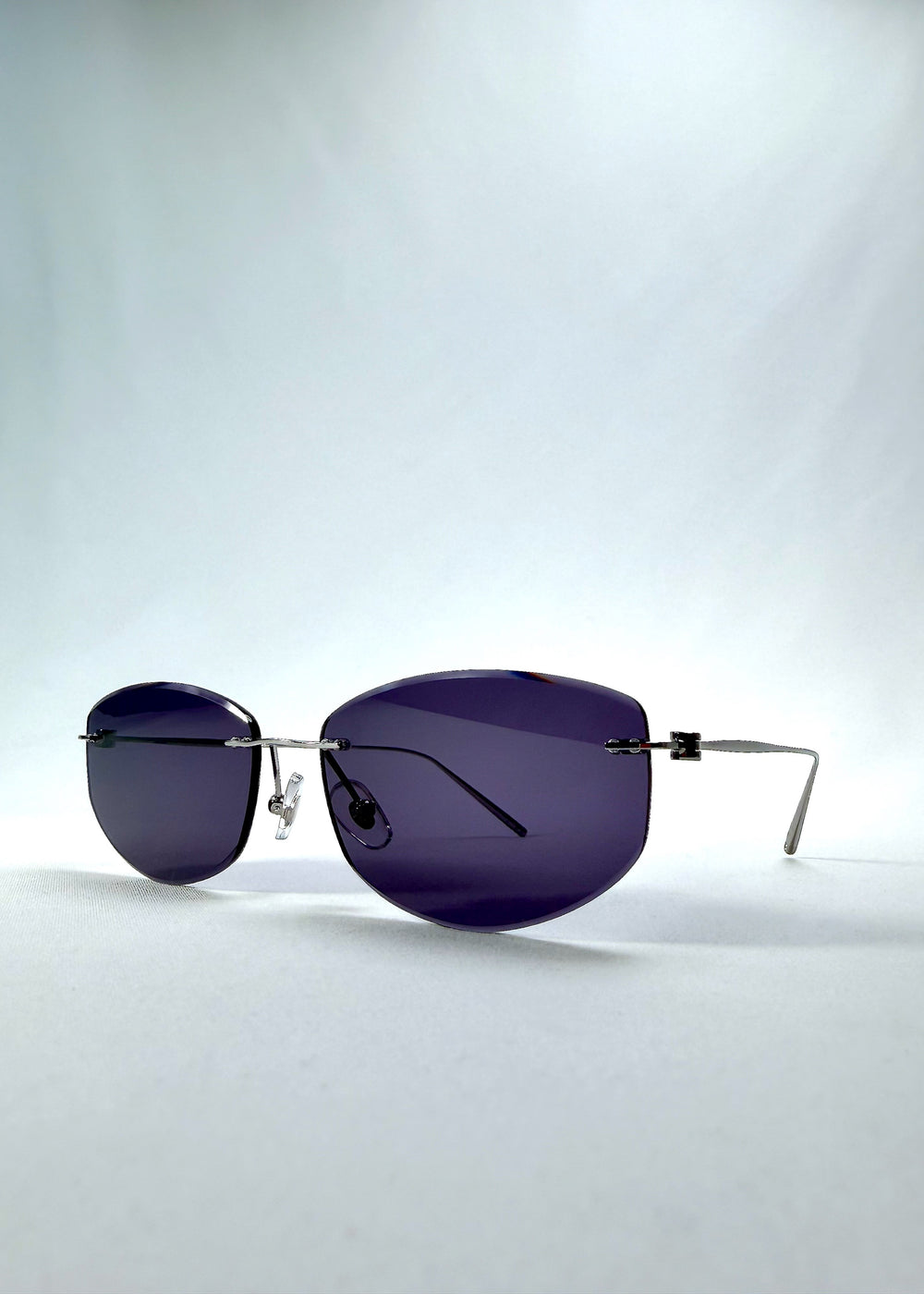 Side view of Halo Trace sunglasses in Glacial Blue, featuring blue-grey nylon lenses and a lightweight titanium frame, showing the lens shape and temple profile.
