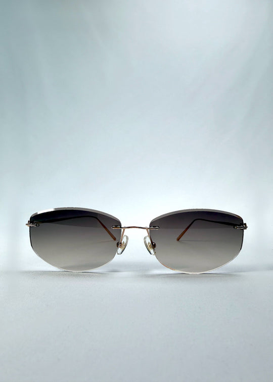 Front view of Halo Trace sunglasses in Verdant Halo, featuring green-to-rose gradient nylon lenses and a lightweight titanium frame, showing the full front silhouette. 