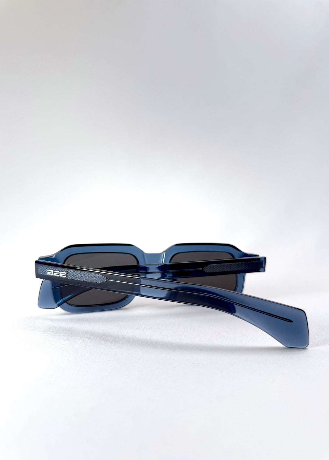 Rear diagonal view of Havoc in Abyss Azure, showcasing the translucent blue acetate frame and wide temples with subtle gradient tones. 