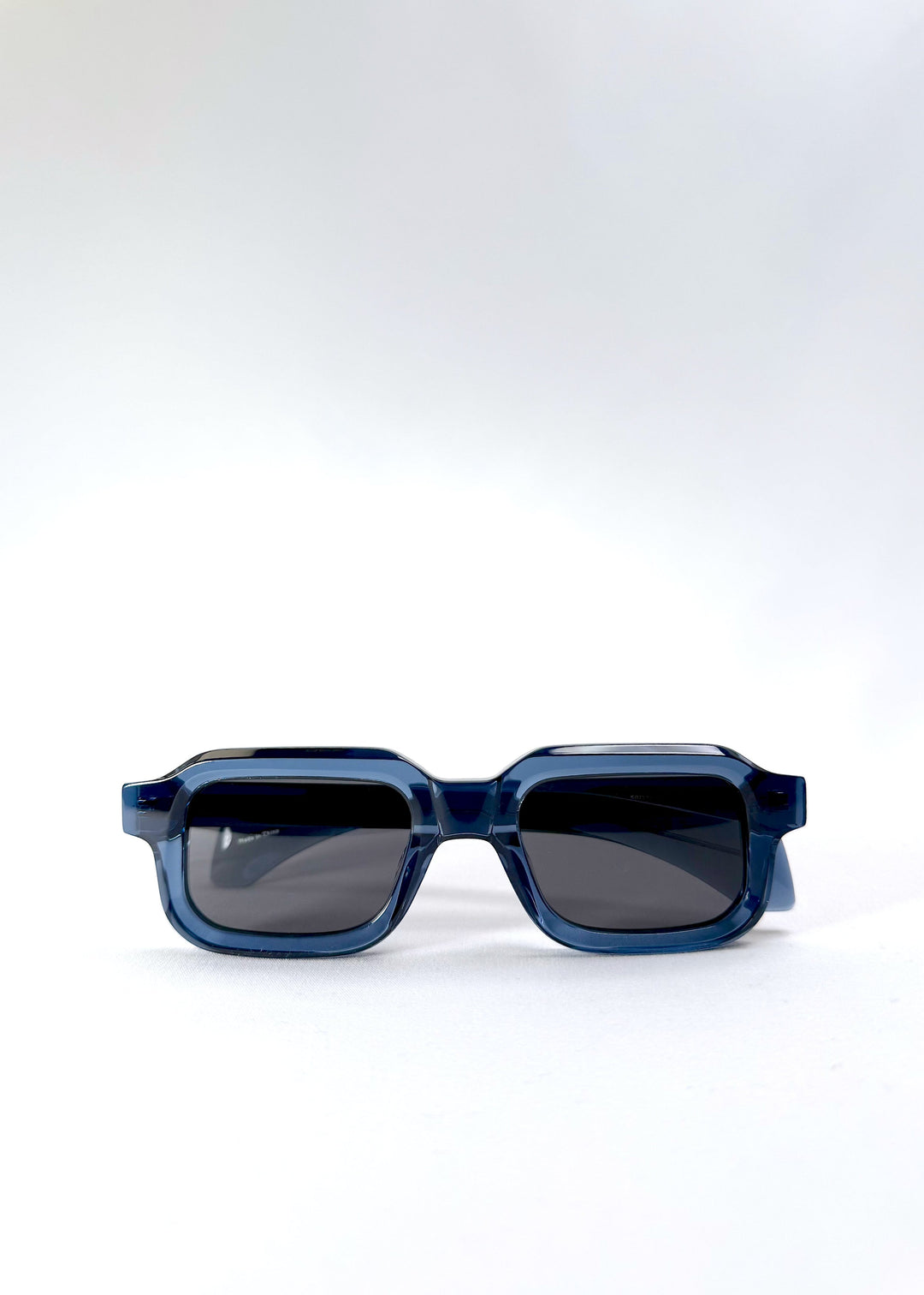 Front view of Havoc in Abyss Azure, showcasing the bold rectangular shape and translucent blue acetate frame with dark polarized lenses. 