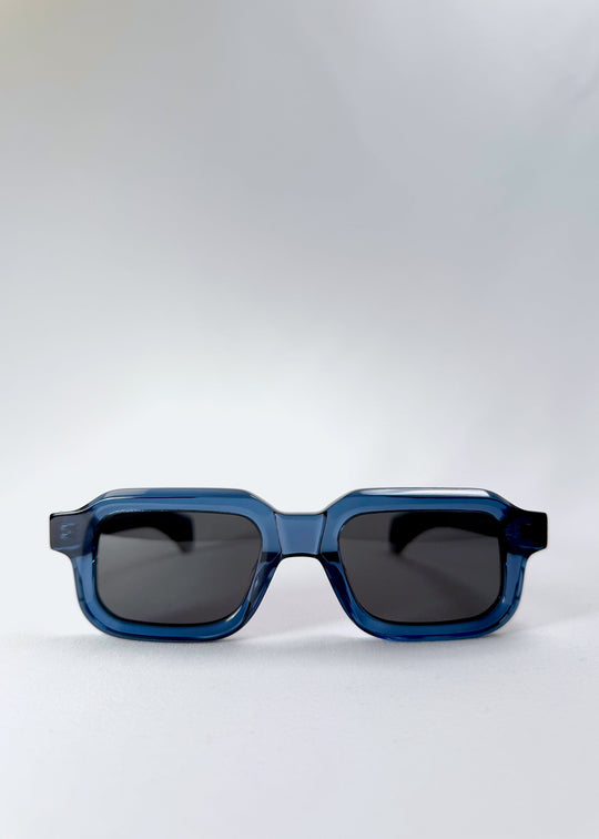 Front flat view of Havoc in Abyss Azure prescription sunglasses, highlighting the bold rectangular silhouette and smoky polarized lenses. 