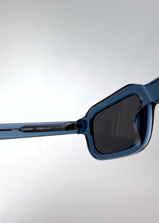 Close-up of Havoc in Abyss Azure showing the inner temple with engraved model code and textured acetate pattern. 