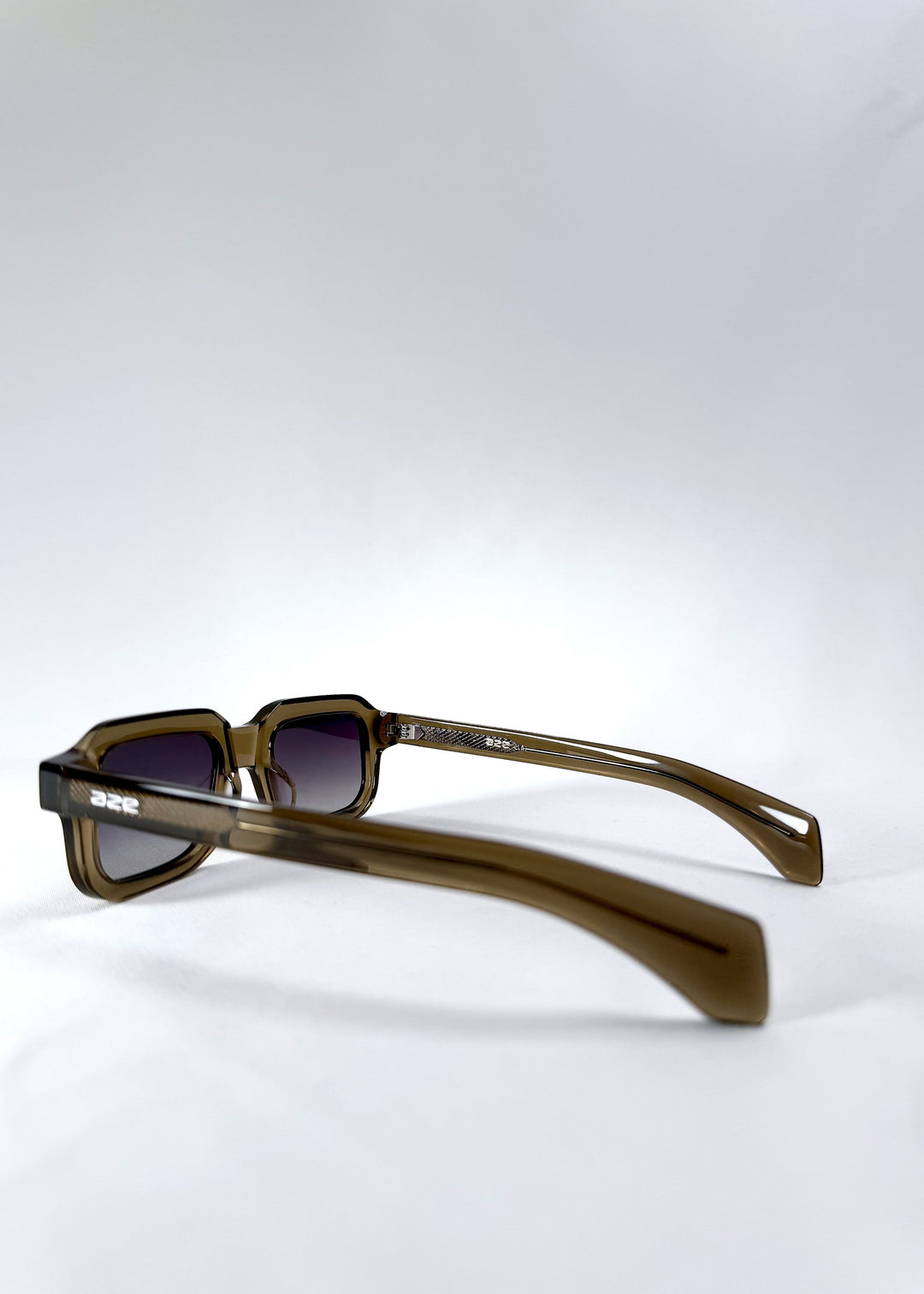 Back-angle view of Havoc in Ember Fade, showing the smooth olive acetate temples and embedded AZE branding. 
