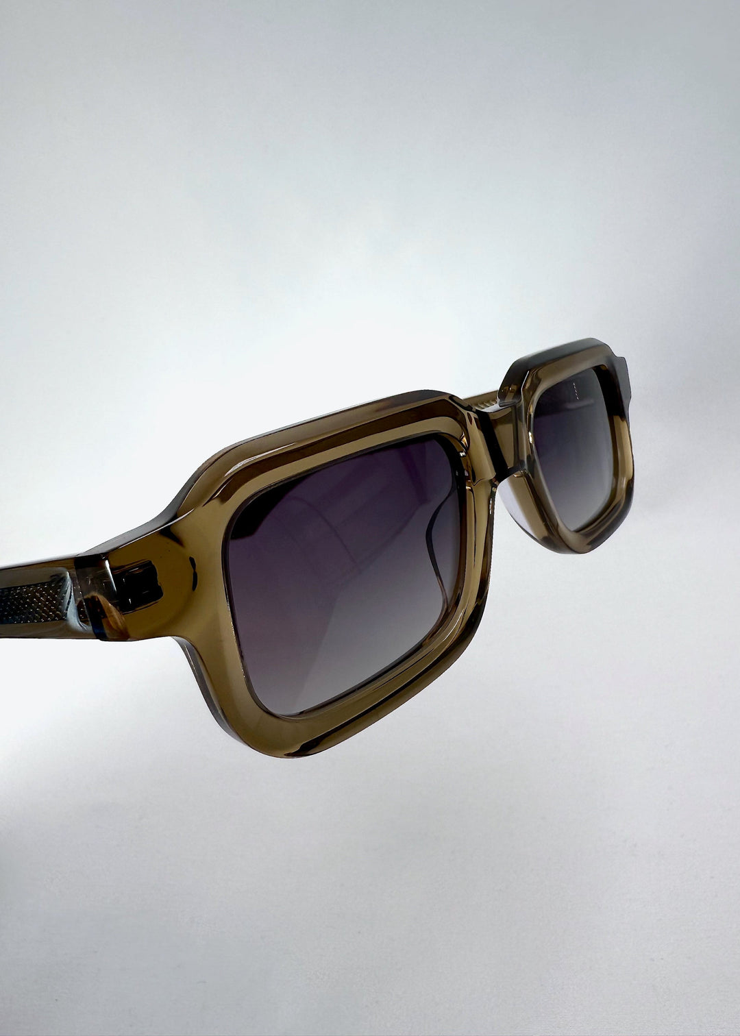 Close-up of the front frame and lens edge of Havoc in Ember Fade, showing the sculpted translucent olive acetate. 