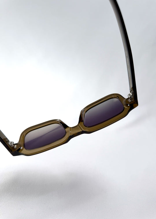 Top-down inside view of Havoc in Ember Fade, showing the translucent olive-green frame and violet-to-grey gradient lenses. 