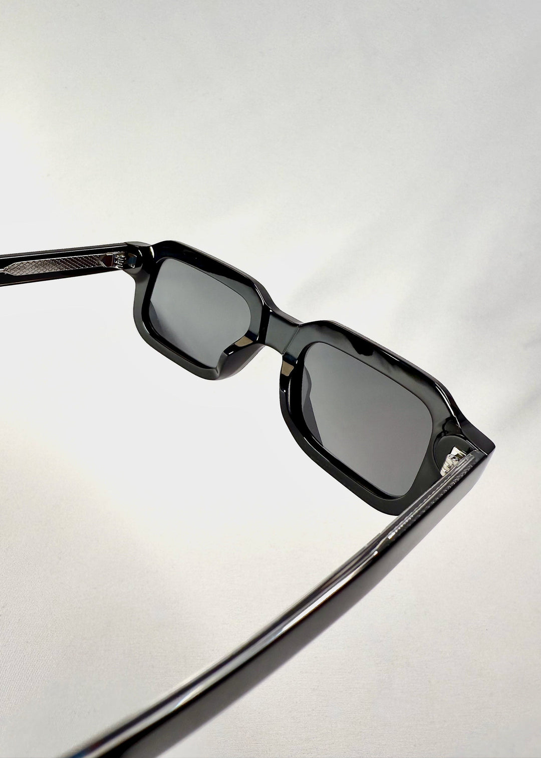 Detailed shot of the lens and nose bridge of Havoc in Obsidian Black, showing the smooth contours and seamless acetate craftsmanship. 