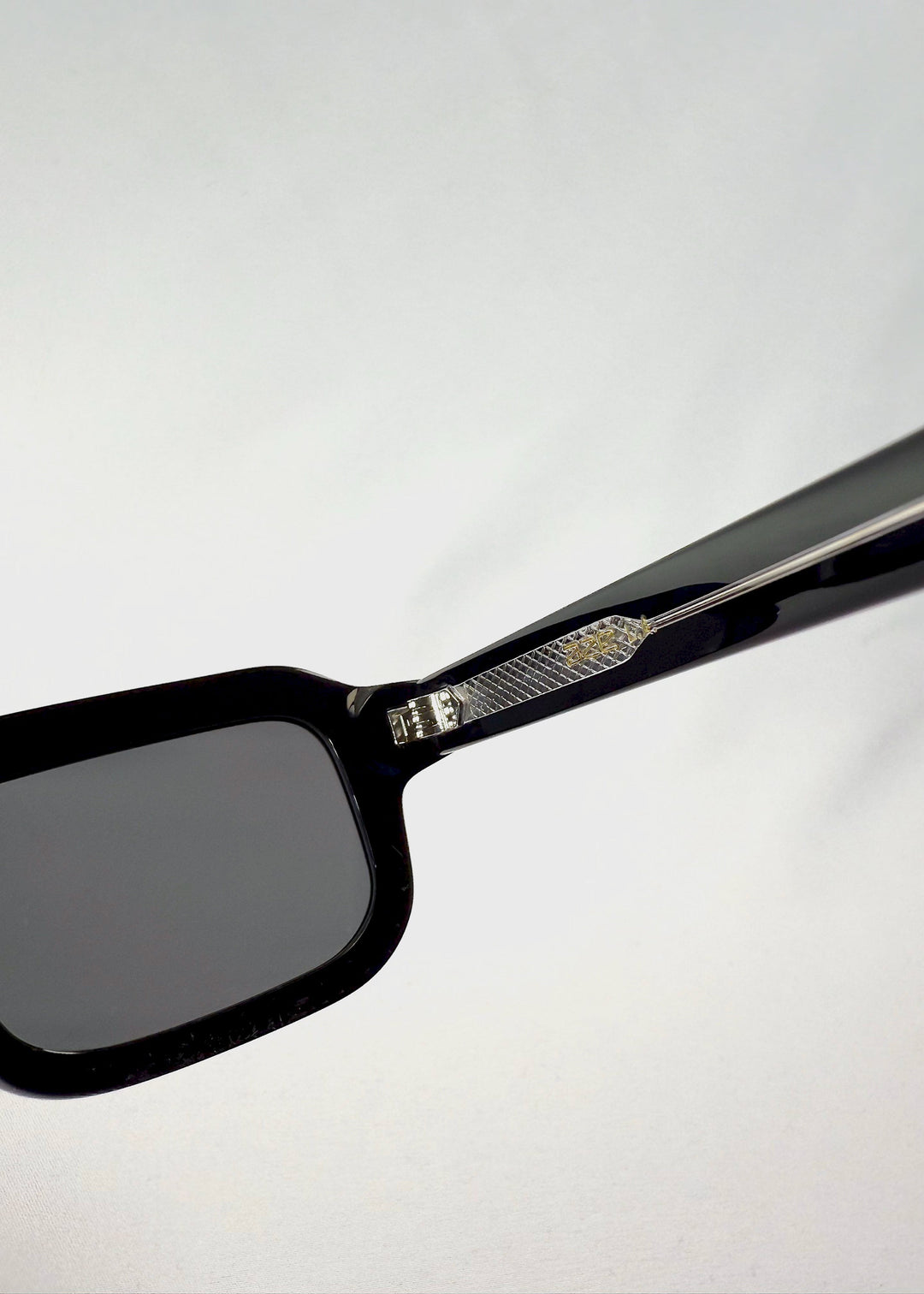 Close-up of the Havoc sunglasses temple in Obsidian Black, highlighting the inner metal structure and hinge detailing. 