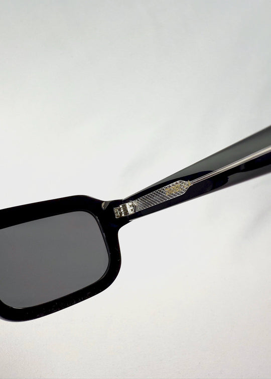 Close-up of the Havoc sunglasses temple in Obsidian Black, highlighting the inner metal structure and hinge detailing. 