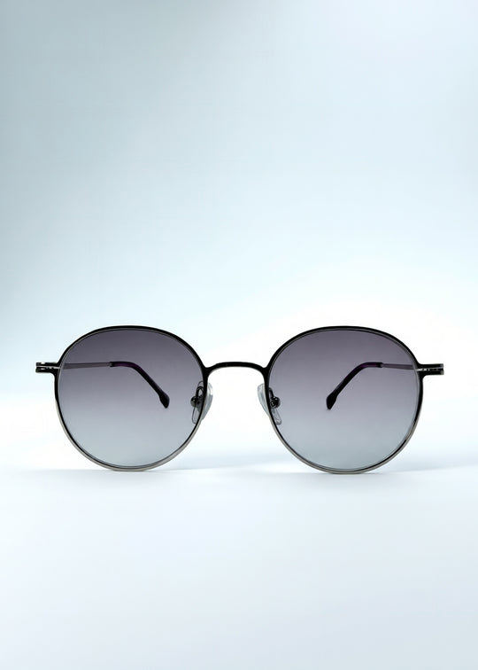 Front view of AZE Liora Arc sunglasses in Moonlit Silver, featuring a silver-tone round frame and gray gradient lenses, showing the full front silhouette.