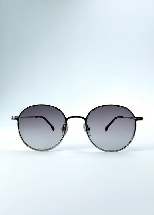 Front view of AZE Liora Arc sunglasses in Moonlit Silver, featuring a silver-tone round frame and gray gradient lenses, showing the full front silhouette. 