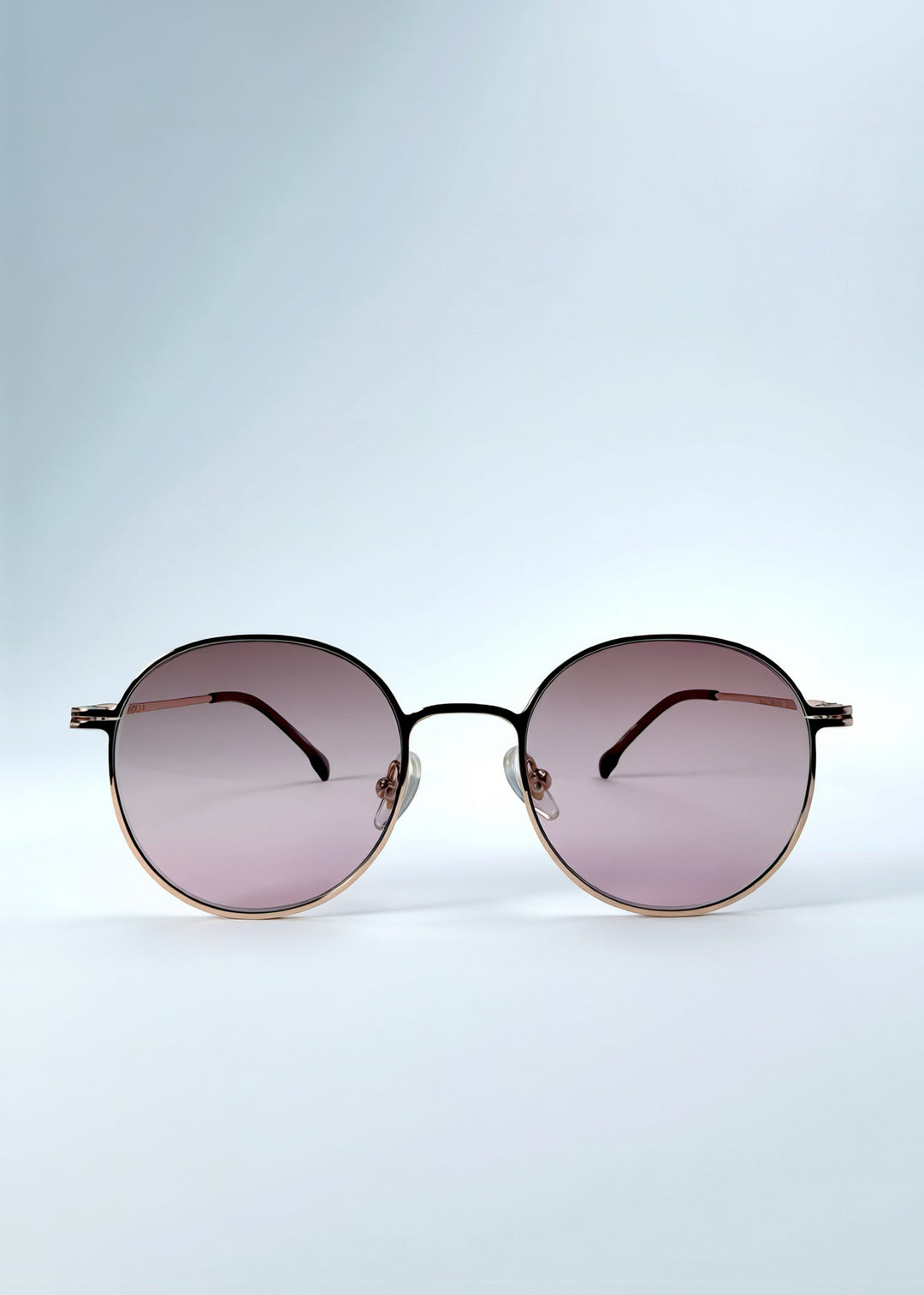 Front view of AZE Liora Arc sunglasses in Rosé Dawn, featuring a rose-gold-tone round frame and soft rose gradient lenses, showing the full front silhouette.