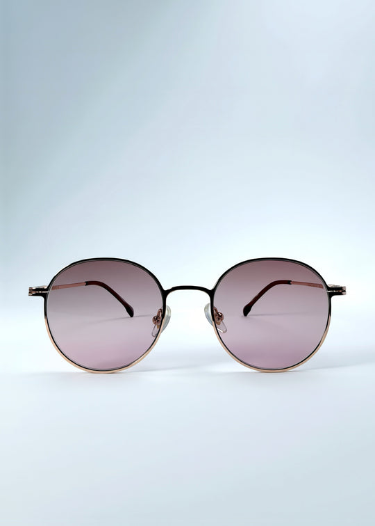 Front view of AZE Liora Arc sunglasses in Rosé Dawn, featuring a rose-gold-tone round frame and soft rose gradient lenses, showing the full front silhouette.
