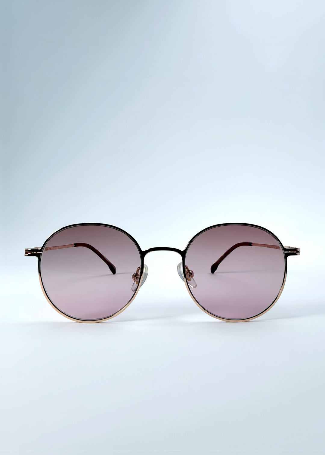 Front view of AZE Liora Arc sunglasses in Rosé Dawn, featuring a rose-gold-tone round frame and soft rose gradient lenses, showing the full front silhouette. 