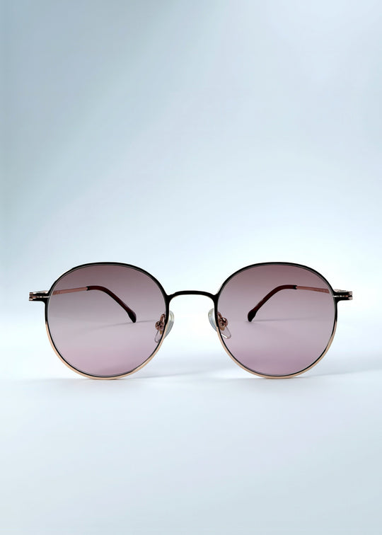 Front view of AZE Liora Arc sunglasses in Rosé Dawn, featuring a rose-gold-tone round frame and soft rose gradient lenses, showing the full front silhouette. 
