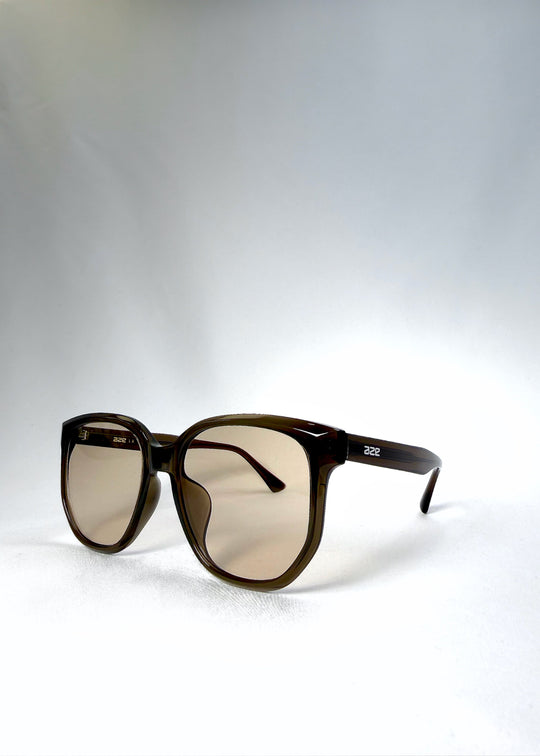 Angled front view of Lucent Rift in Sepia Veil highlighting the floating brow line and beige-brown lenses. 