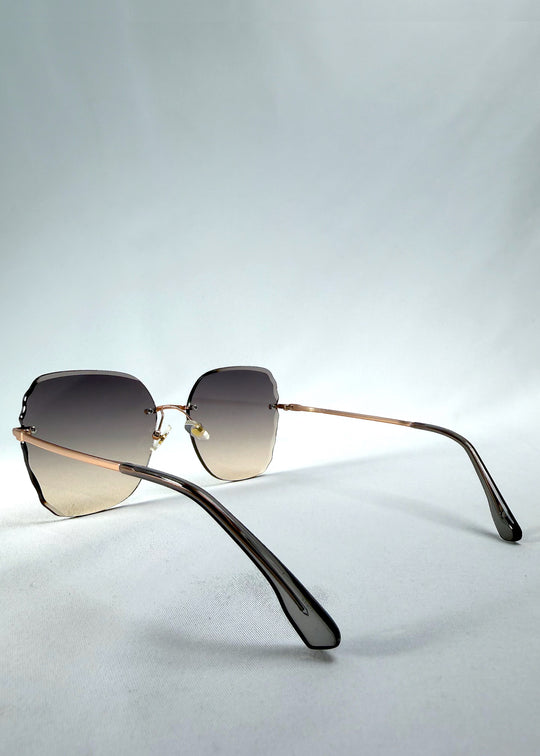 Back-angle view of Lucera sunglasses in Taupe Veil, featuring rimless gold-tone frame and taupe gradient lenses, showing the back structure and temple alignment.