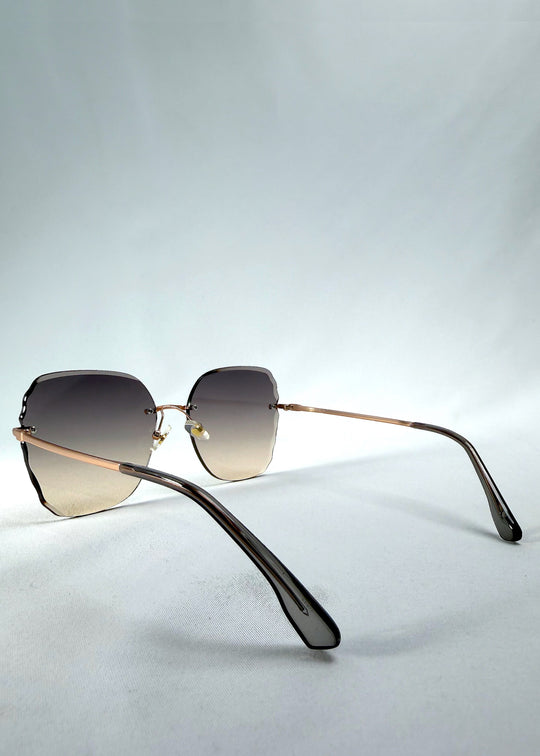 Back-angle view of Lucera sunglasses in Taupe Veil, featuring rimless gold-tone frame and taupe gradient lenses, showing the back structure and temple alignment. 