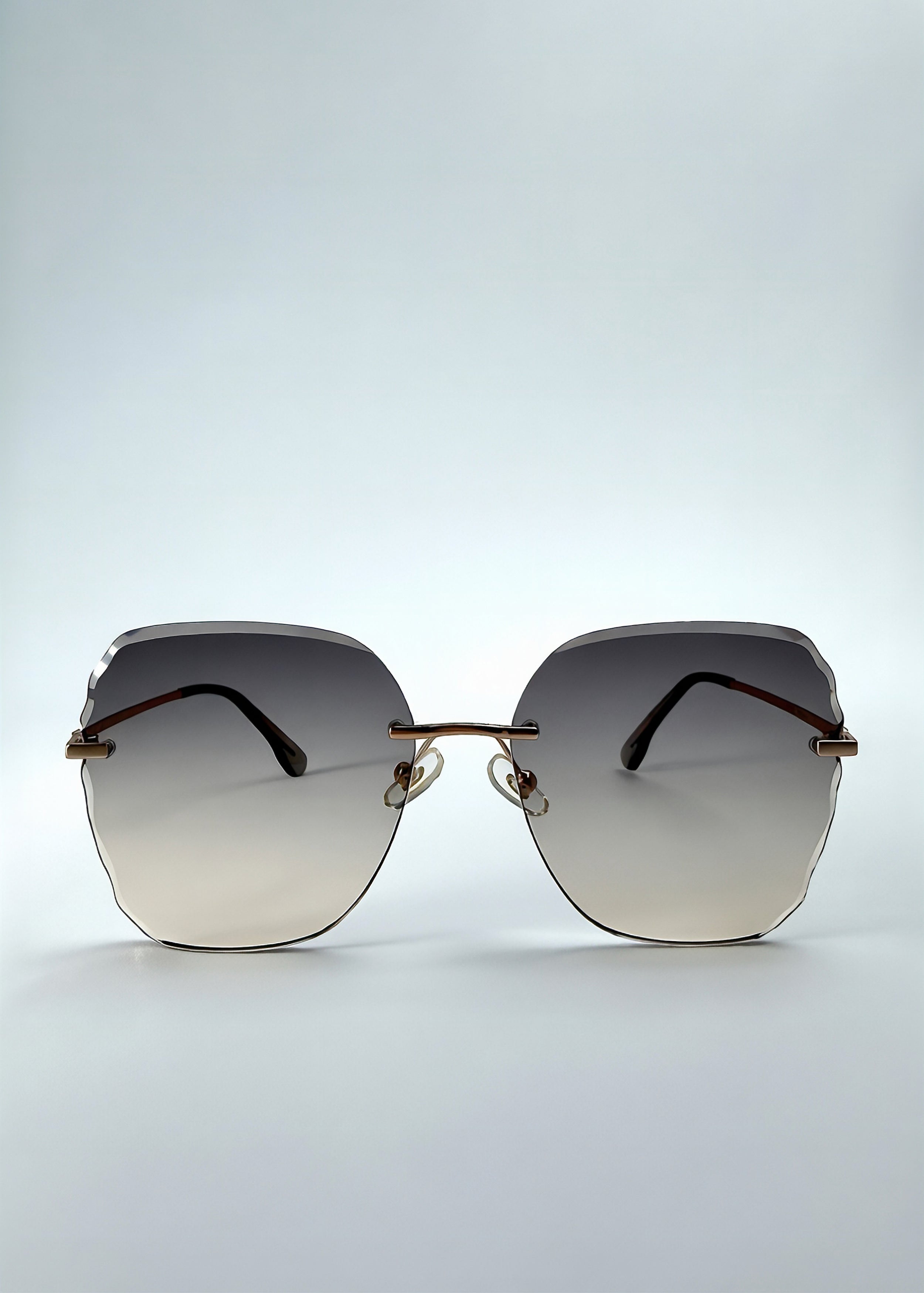 Front view of Lucera sunglasses in Taupe Veil, featuring rimless gold-tone frame and taupe gradient lenses, showing the full front silhouette.