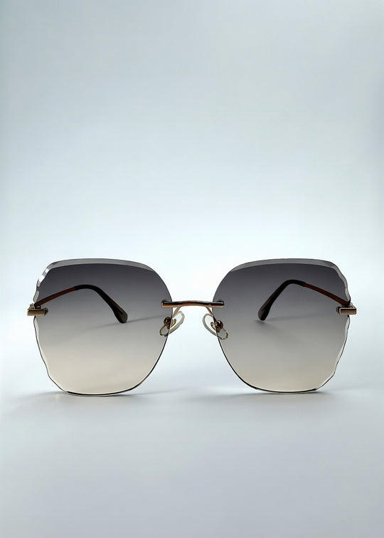 Front view of Lucera sunglasses in Taupe Veil, featuring rimless gold-tone frame and taupe gradient lenses, showing the full front silhouette. 