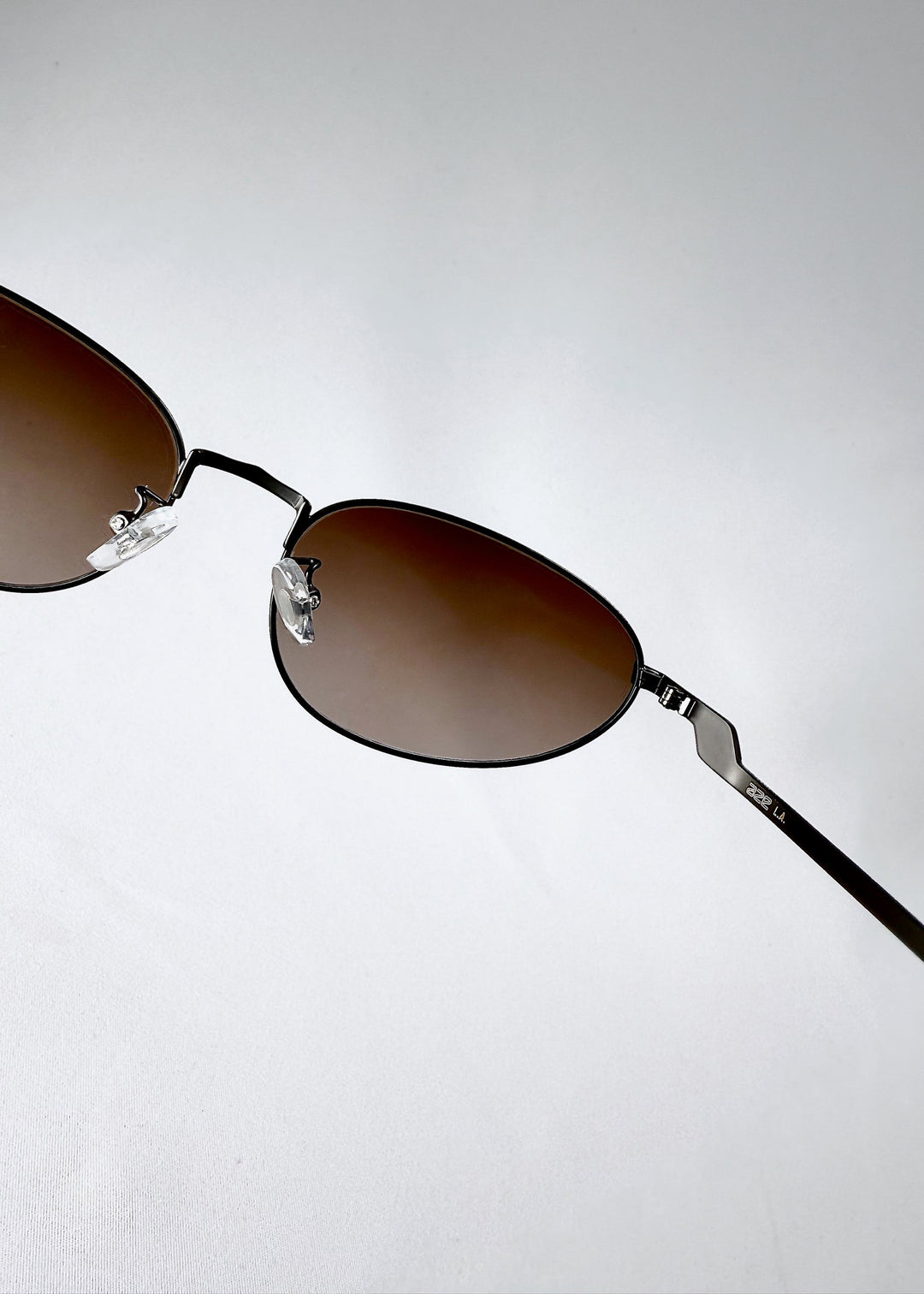 Back view of Lunaris - Dusk Bronze sunglasses, emphasizing the lightweight arms and balanced temple curve. 