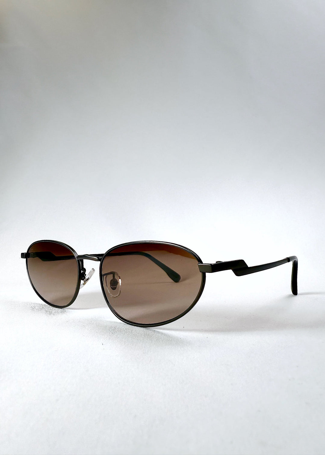 Front angle view of Lunaris - Dusk Bronze sunglasses, highlighting the warm bronze frame and soft lens gradient. 