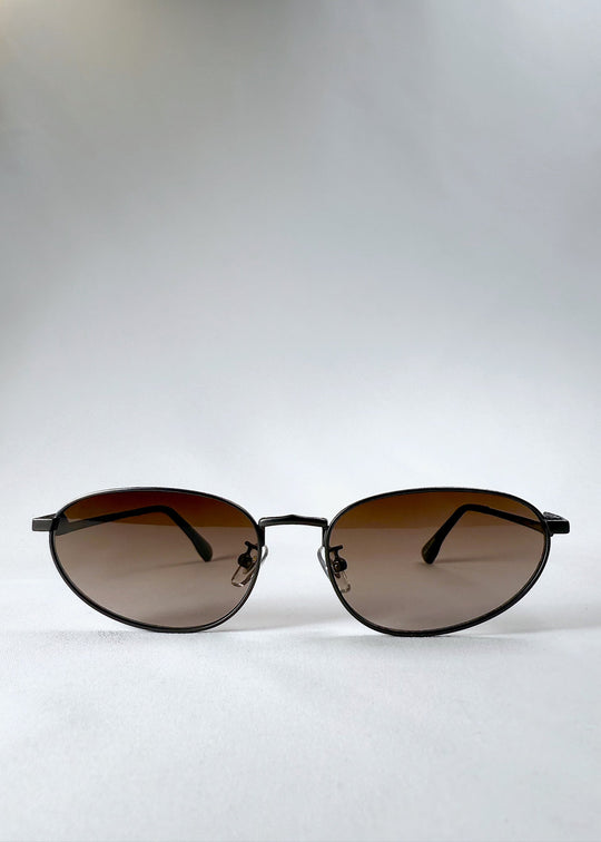 Front view of Lunaris - Dusk Bronze sunglasses, showcasing the full aviator frame with gradient tea lenses and brushed bronze finish. 