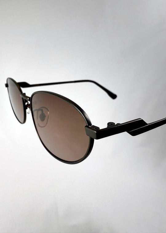 Close-up of Lunaris - Dusk Bronze lenses, featuring the gradient tea tint and smooth lens curvature. 