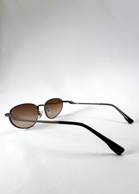 Side view of Lunaris - Dusk Bronze sunglasses, showing the curved temple and adjustable nose pads. 