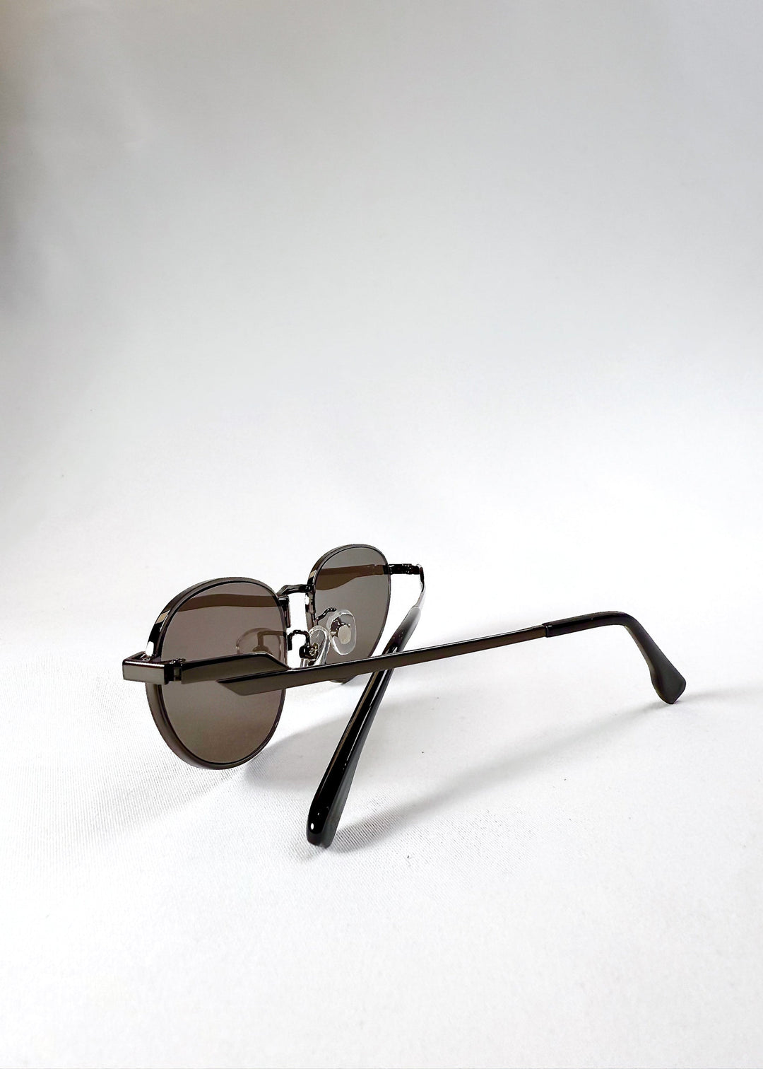 Back view of Lunaris - Iron Ember in folded position, showing ergonomic temples and minimal rear profile. 