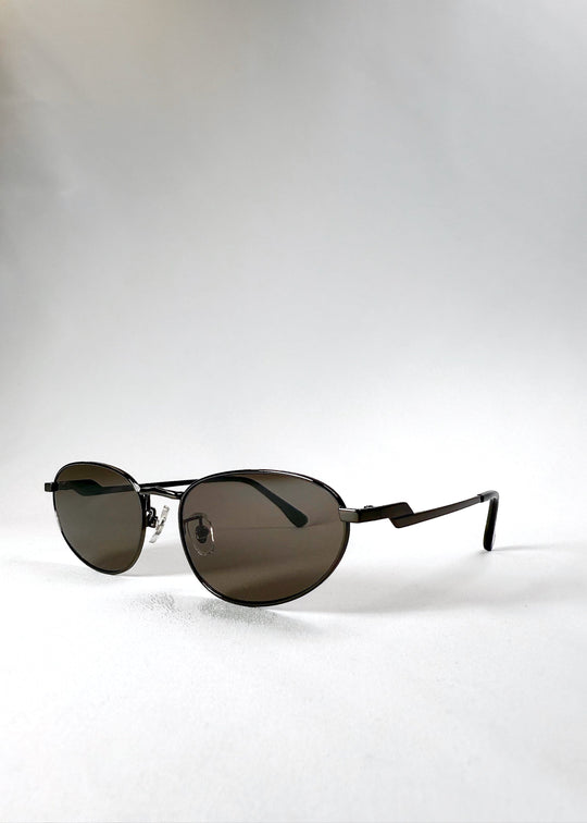 Angled front view of Lunaris - Iron Ember sunglasses, emphasizing the deep-toned lenses and structured aviator shape. 